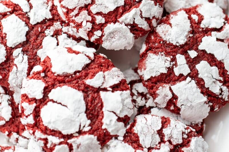 A closeup of a plate of red velvet crinkle cookies.
