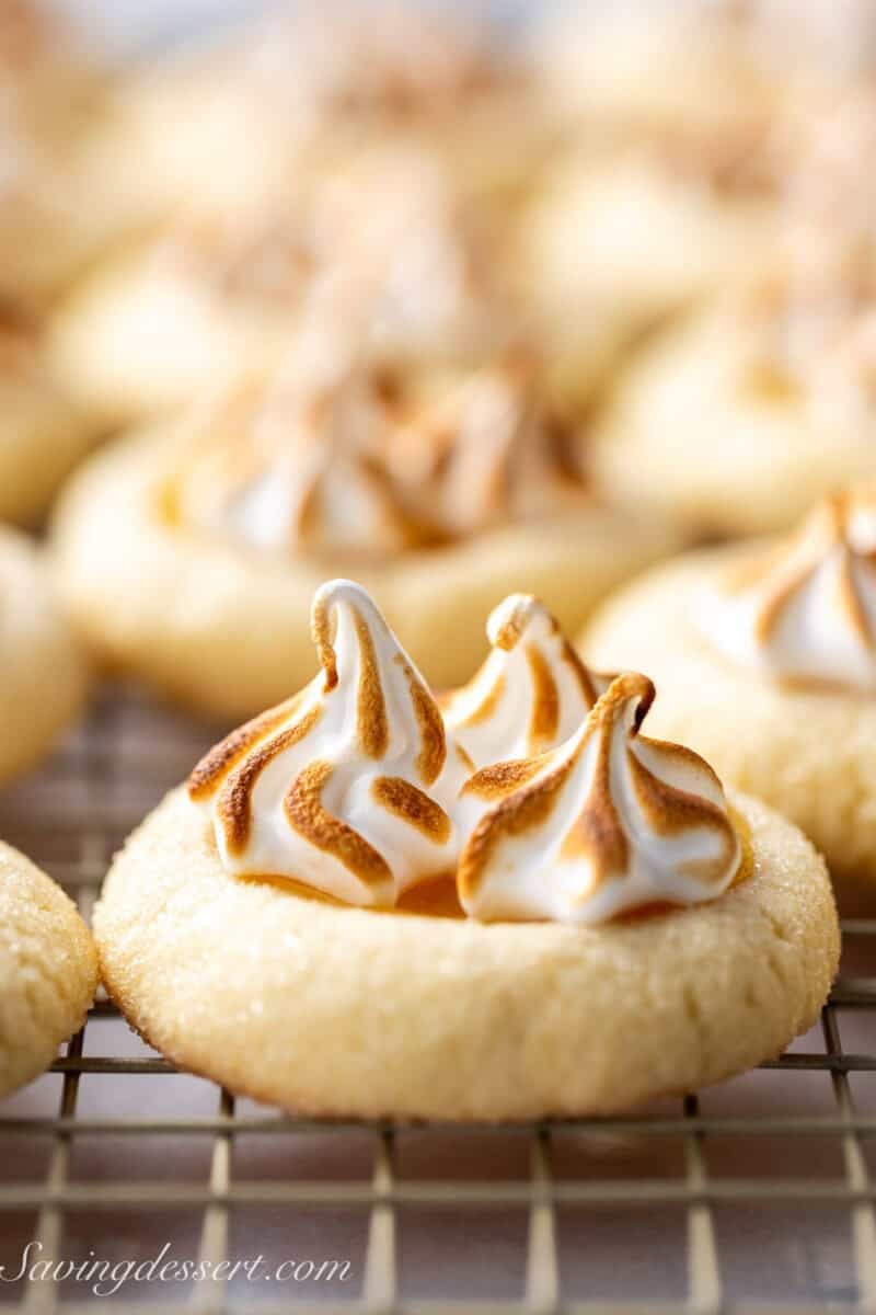 A side view of a lemon meringue pie cookie topped with toasted swirls.