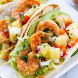 A close up of shrimp tacos with well spiced shrimp and pineapple salsa.