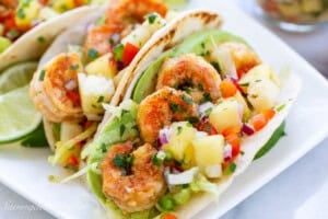 A close up of shrimp tacos with well spiced shrimp and pineapple salsa.