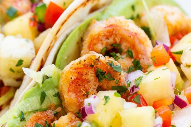 A closeup of shrimp tacos with pineapple salsa.