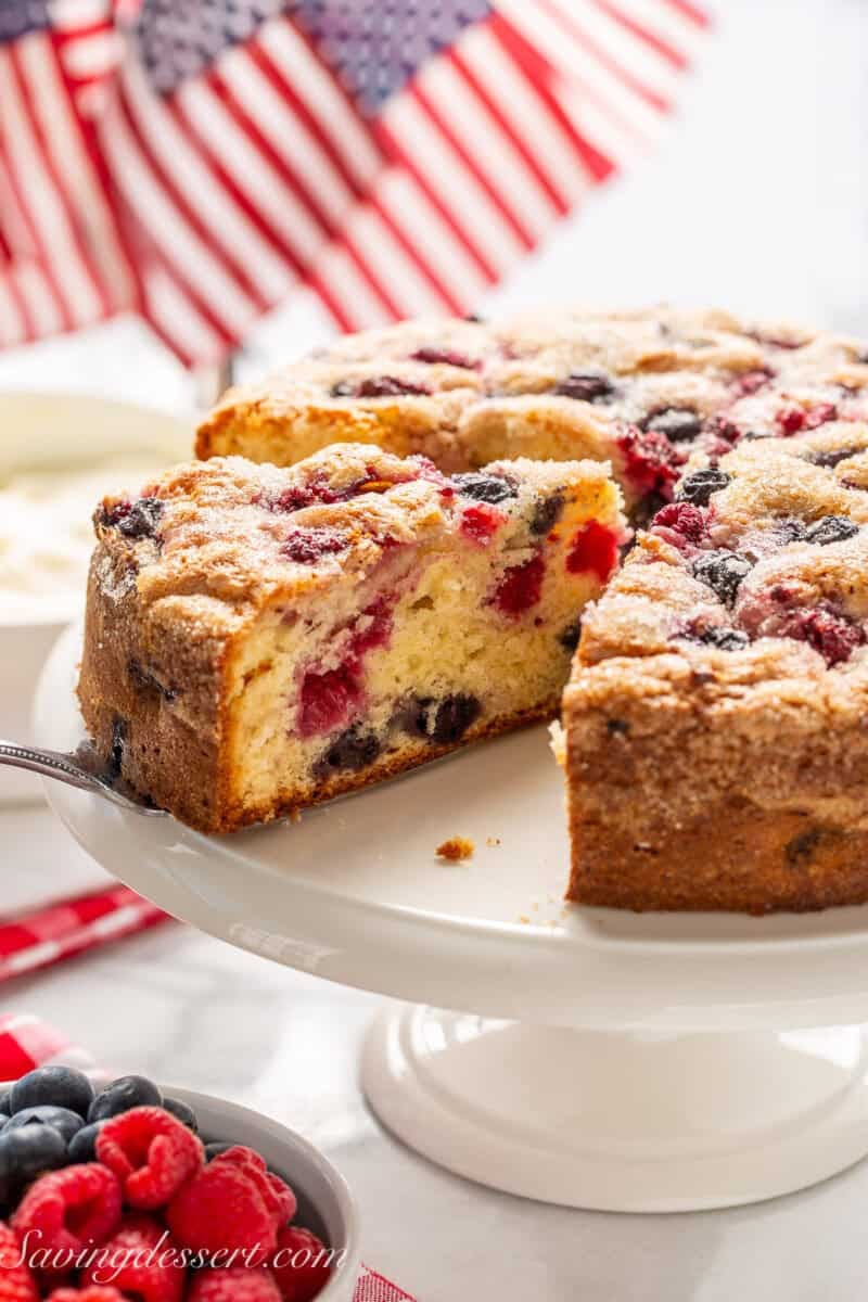 A single layer summer berry cake on a cake stand.