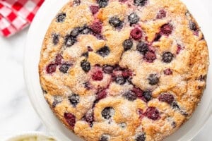 An overhead photo of a single layered berry packed cake with a crunchy sugary top.