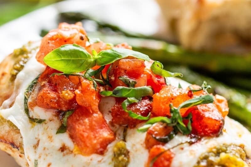 A piece of chicken caprese on a platter.