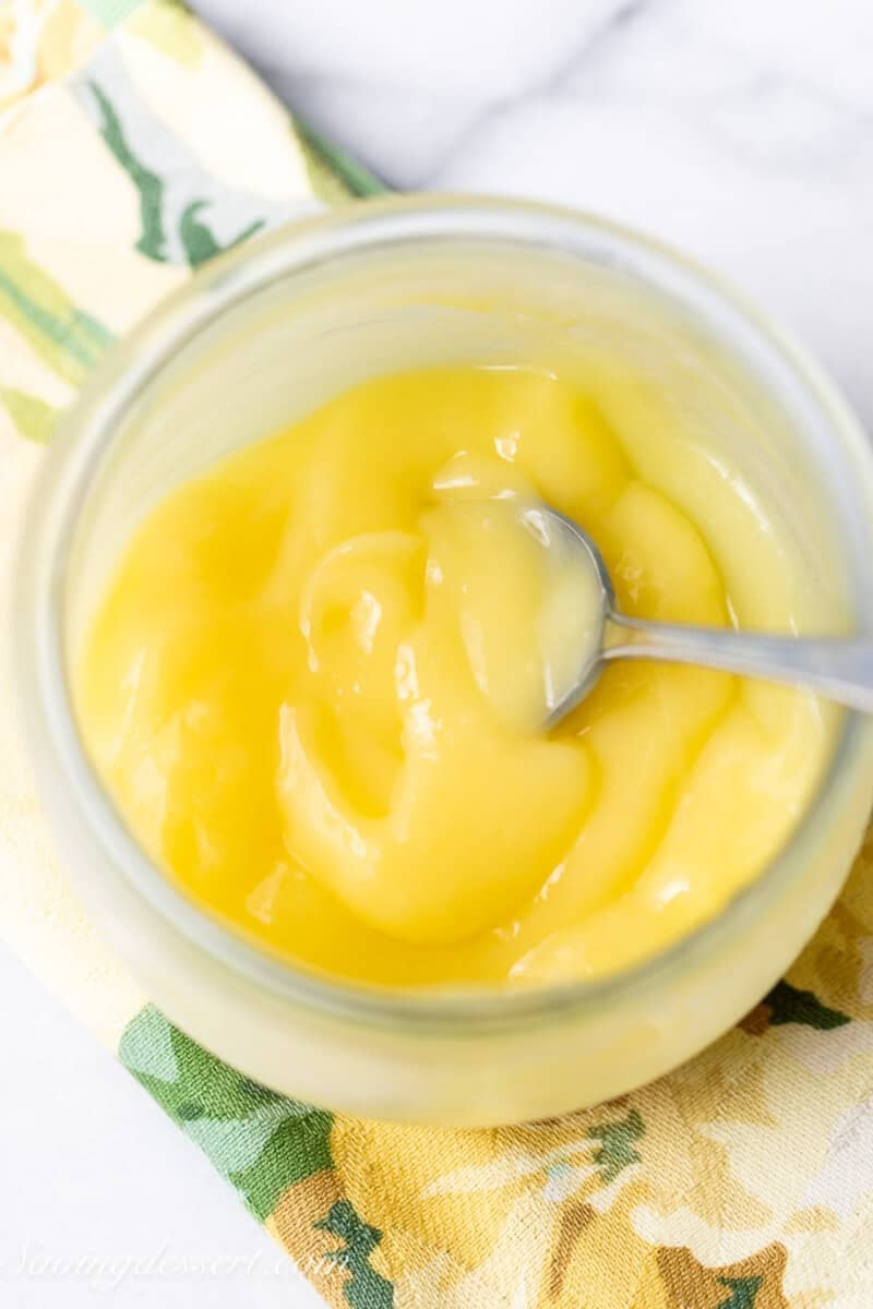 An overhead view of a jar of cold and thick key lime curd.