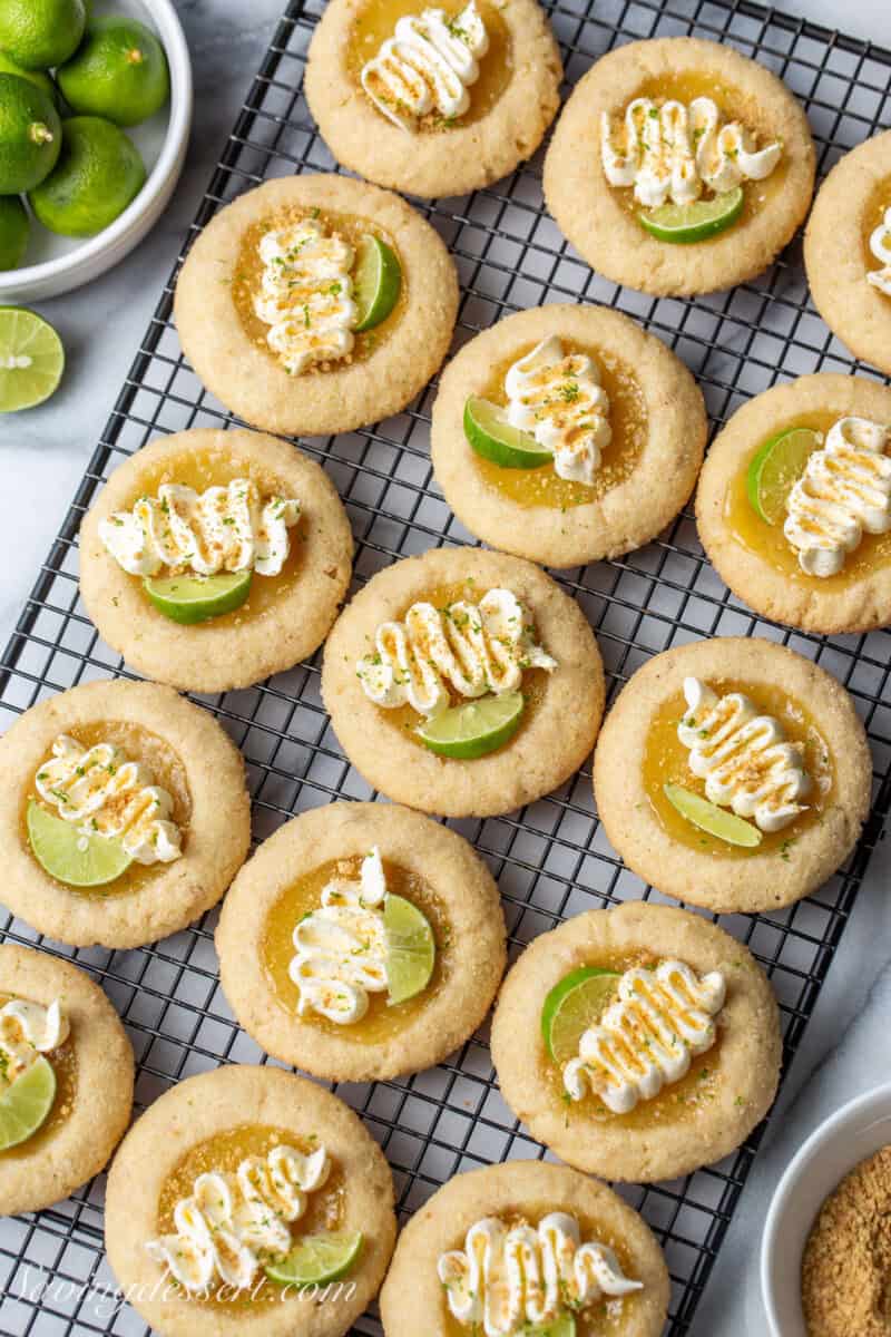 An overhead view of key lime pie cookies decorated with whipped cream and graham cracker crumbs.
