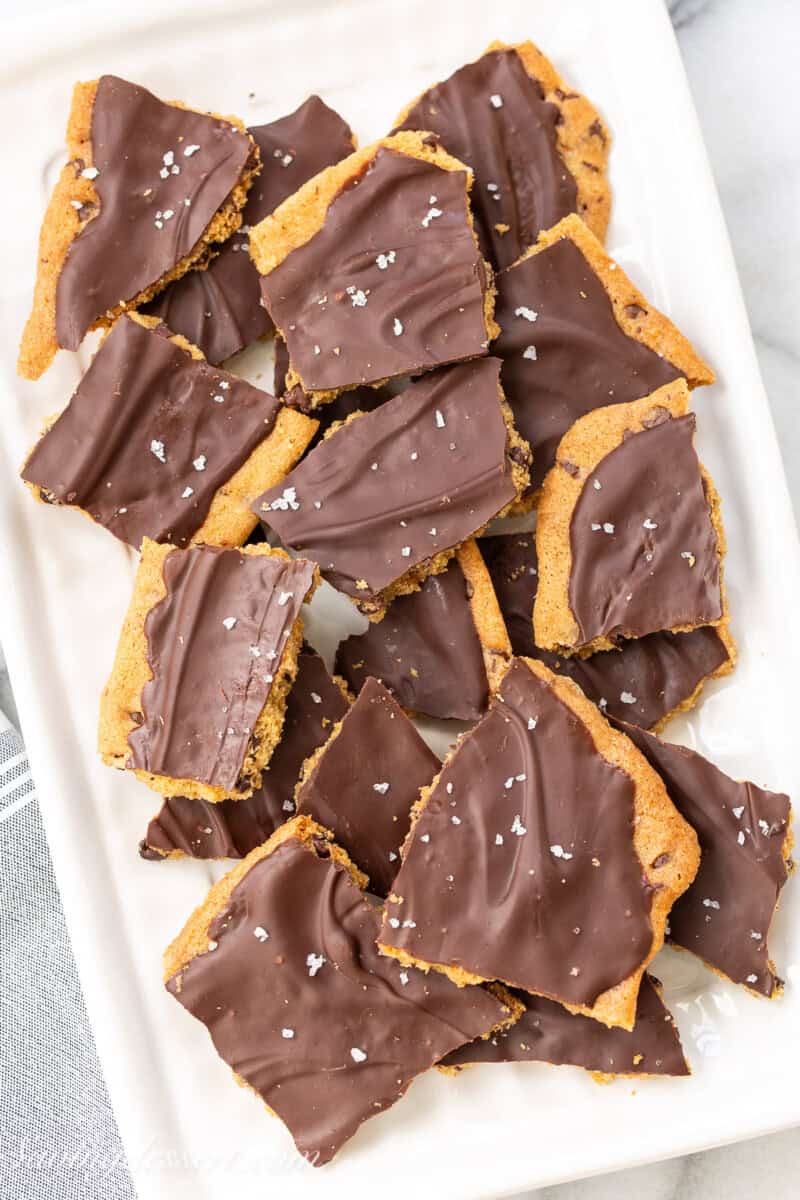 A small platter filled with dark chocolate cookie bark.