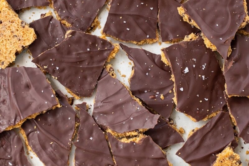 An overhead view of a pan filled with broken up pieces of chocolate chip cookie bark.