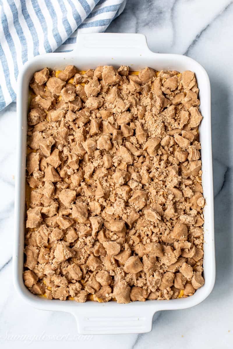 Pumpkin cake with a crumb topping ready to go in the oven.