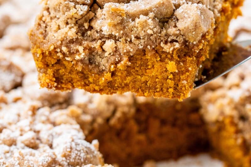 A piece of pumpkin crumb cake on a spatula.